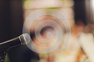 Close up of microphone in concert hall or conference room.