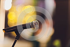 Close up of microphone in concert hall or conference room.