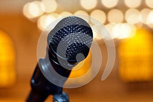 A close up of a microphone in a hall or a conference room, Microphone on a blurred background as in a speech in a seminar room