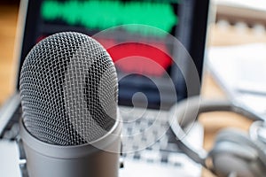 Close Up Of Microphone Laptop And Headphones For Broadcasting Podcast photo