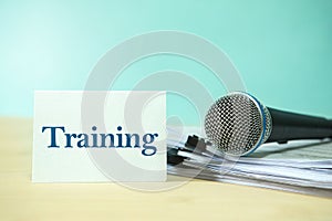 Close up Microphone on a paper document with Training text, con