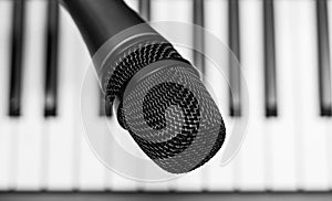Close up microphone on piano keyboard in music studio.