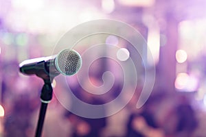 Close up microphone on stage in concert hall restaurant or conference room. Blurred background. Copy space
