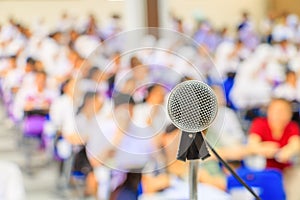 Close up microphone stand on the table in the conference and Background blur interior seminar meeting room.