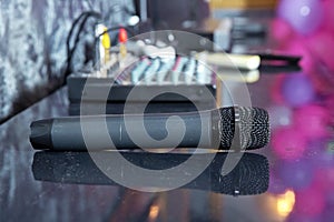 Close up Microphone on the table, concept of speaker or teacher preparation to speak in seminar class room . A black microphone is