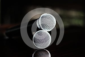 Close up Microphone voice speaker on dark background. radio microphones. wireless sound transmission system. soft focus Two mics C photo