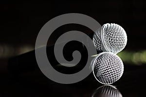 Close up Microphone voice speaker on dark background. radio microphones. wireless sound transmission system. soft focus Two mics C photo