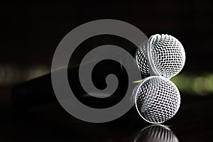 Close up Microphone voice speaker on dark background. radio microphones. wireless sound transmission system. soft focus Two mics C photo