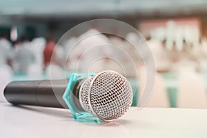 Close up microphone wireless old on table in conference and Background blur interior seminar meeting room