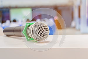 Close up microphone wireless old on table in conference and Background blur interior seminar meeting room