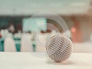 Close up microphone wireless old on table in conference and Background blur interior seminar meeting room. Vintage tone color