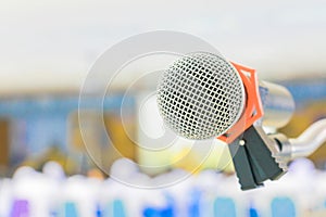 Close up microphone wireless Stand on white table in business conference interior seminar meeting room and Background blur