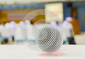 Close up microphone wireless on the table in the conference and Background blur interior seminar meeting room