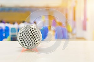 Close up microphone wireless on the white table in business conference interior seminar meeting room