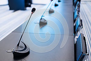 Close-up of microphones in an empty meeting room at a press conference.