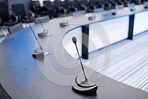 Close-up of microphones in an empty meeting room at a press conference.