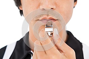 Close up mid section of referee blowing whistle