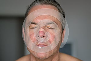 Close up of a middle aged man with a nose tape and a mouth tape