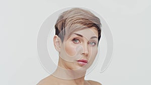 Close-up of middle aged mature woman over white bacjground. Portrait of mature lady. Plastic surgery, beauty injections