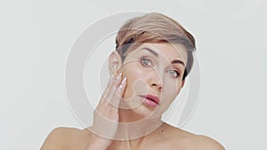 Close-up of middle aged mature woman over white bacjground. Portrait of mature lady. Plastic surgery, beauty injections