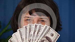 Close up Middle aged woman holding in hands money cash dollar banknotes. American cash money in female hands. Concept of