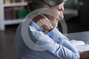Close up middle-aged woman suffering from neck pain