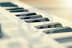 Close up of MIDI controller volume fader, knob and keys.