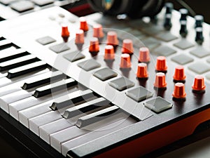Close-up. MIDI keyboard. Modern musical equipment for recording studio, music studio. Sound work, podcast. Workplace of a sound
