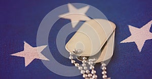 Close up of military dog tags american flag background with copy space