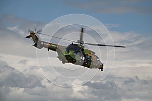 A military helicopter is flying in the clear blue sky, demonstrating power and advanced technology. puma photo