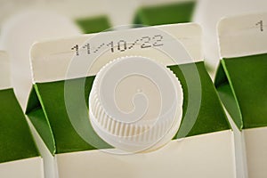 Close-up of milk cartons with expiration date photo