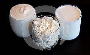 Close up milk, cottage, soure cream or yogurt in glasses photo