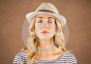 Close up of millennial woman eyes closed against brown grunge background