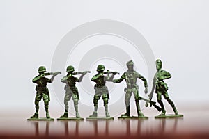 Close-up of miniature a group of plastic toys soldiers at war.