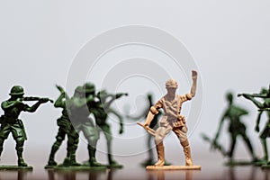 Close-up of miniature a group of plastic toys soldiers at war.