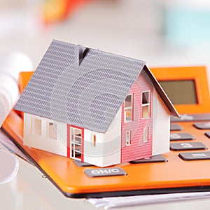 Close up Miniature House on Top of a Calculator photo