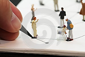 close up of miniature people with social network diagram on open