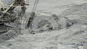 Close-up of mining excavator scooped up the ore with a bucket. Quarry mining equipment.