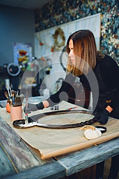 Close-up of the mirror frame in the hands of the designer.