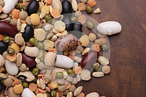 Close-up mixed colorful legumes and grains on a wooden table