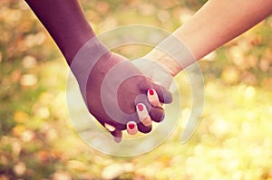 Close up on a mixed race couple holding hands