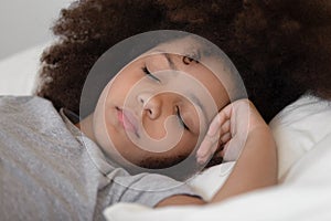 Close up mixed race cute peaceful child girl napping.