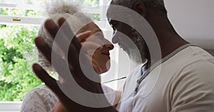 Close up of mixed race senior couple dancing together in the kitchen at home