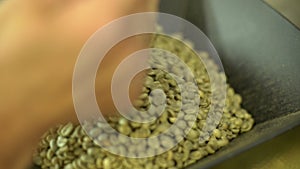 Close-up of mixing and stirred quality black coffee beans in roasting machine