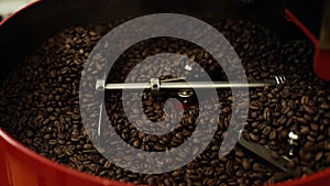 Close-up of mixing and stirred quality black coffee beans in roasting machine