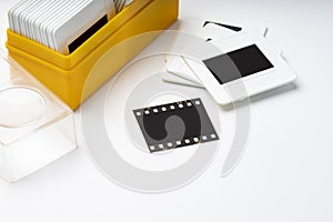 Close up of 35mm slide film and box on white background , Analog vintage records of memories in 1970s