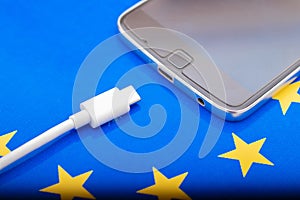 Close up Mobile phone Charger with USB Type - C cord on EU Flag photo
