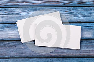 Close-up of two empty stacks of business cards on a blue-violet natural wooden background