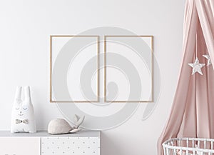 Close up for mock up wooden frame in Scandinavian kids bedroom with white wooden crib for newborn baby.