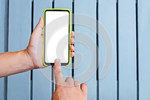 Close-up, Mockup of a smartphone in the hands of a man against the background of a gray rhythmic wooden wall